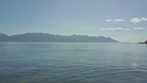 Girl swimming on back in ocean water — Stock Video