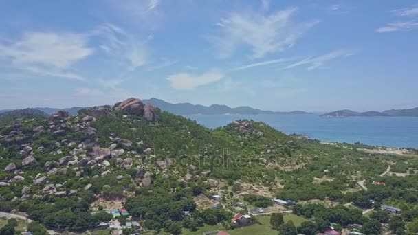 Hilly peninsula with fishermen village against sea — Stock Video