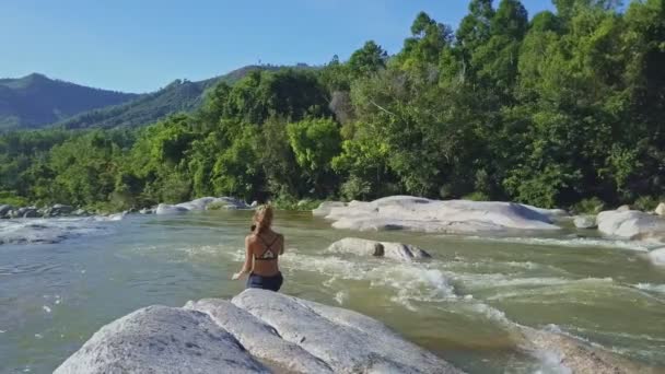 Girl taking photos among river rapids — Stock Video