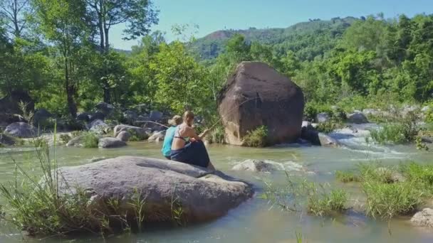 Люди рыбачат в горной реке — стоковое видео