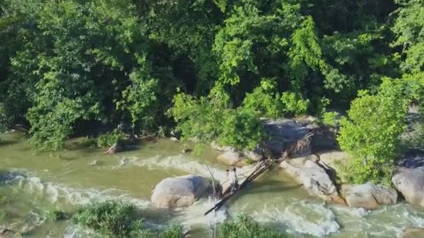 Homens cruzando pedra rio de montanha — Vídeo de Stock