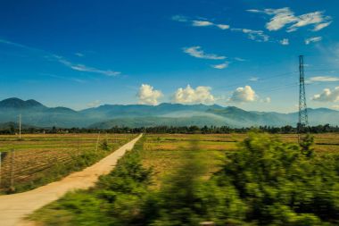 kırsal yere yol alanlar karşı uzak tepeler ve mavi gökyüzü boyunca