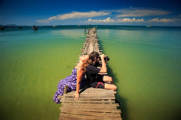 Guy make photos with girl lying on him — Stock Photo, Image