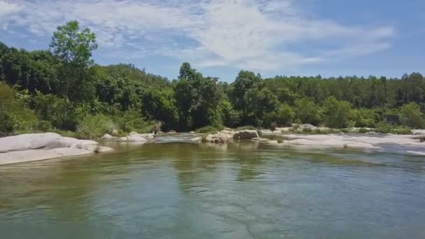 Men going along river and stones — стокове відео