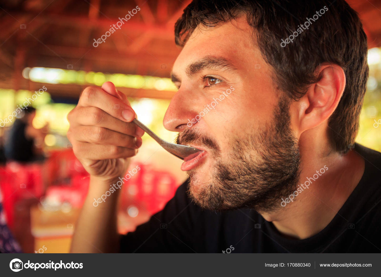 Closeup Bearded Guy Black Shirt Eats Table Spoon Cafe Flowery