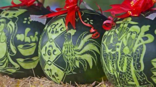 Watermelons stand on hay and decorated with ribbons — Stock Video