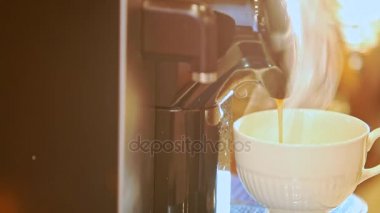 Buhar beyaz fincan içine dökme lezzetli sıcak kahve closeup modern siyah kahve makinesi başlar