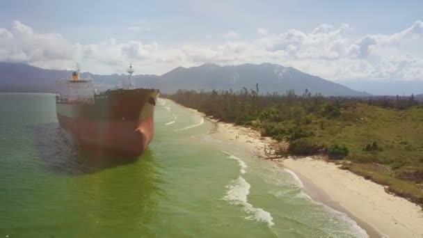 ハリケーン後の絵の風景に対して側面喫水線に沿って海銀行に座礁タンカー船尾からの Flycame の動き — ストック動画