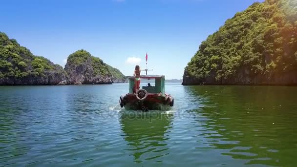 ビキニの金髪少女絵紺碧の海湾と島々 一緒にスピード ボート弓の上に立つベトナム 2017 裏面表示 — ストック動画