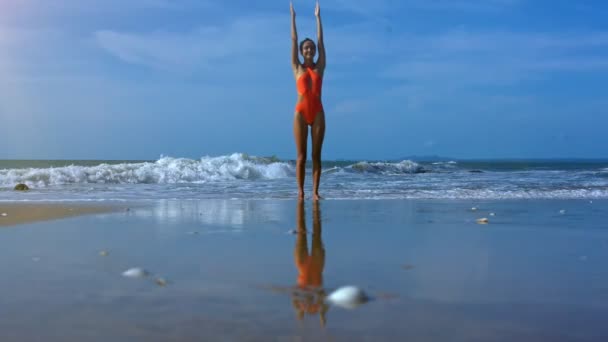 Slim Blond Girl Open Orange Swimsuit Does Yoga Exercise Hands — Stock Video