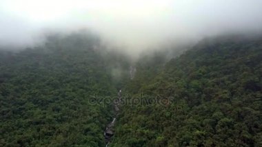 tropikal ormanları ve arka planda derin sis kaplı dağ hızlı nehirde yukarıda resimsel havadan görünümü