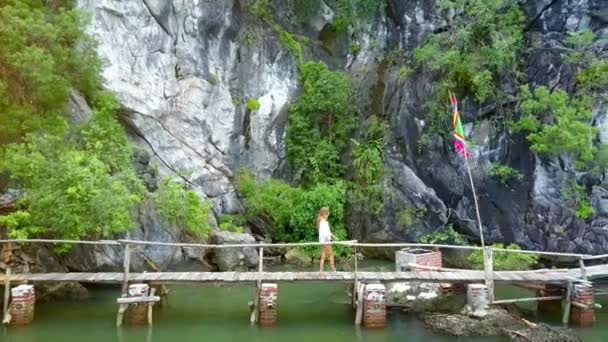 Drone Follows Fair Haired Young Girl Walking Wooden Bridge Sea — Stock Video