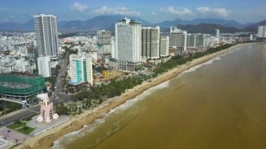 panoramik sarı deniz plaj ve insanlar city karşı güçlü kasırga sonra kıyıya taşınan çöp toplamak