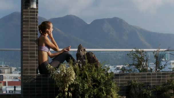 Close View Blonde Lady Sits Roof Top Terrace Leaning Brick — Stock Video