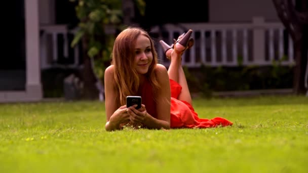 Closeup Cute Blonde Long Haired Girl Smiles Resting Green Grass — Stock Video