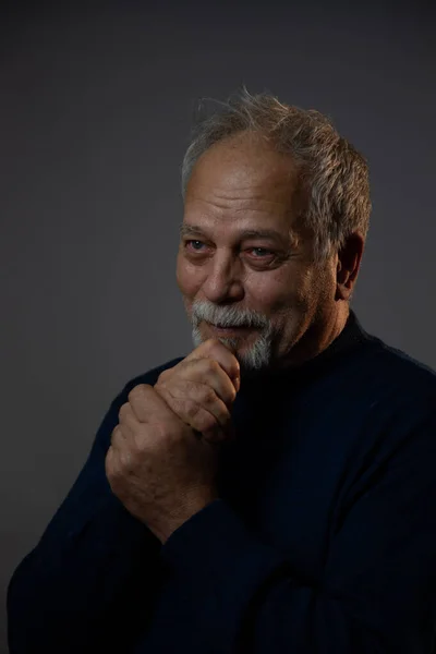 Happy old man on gray studio background