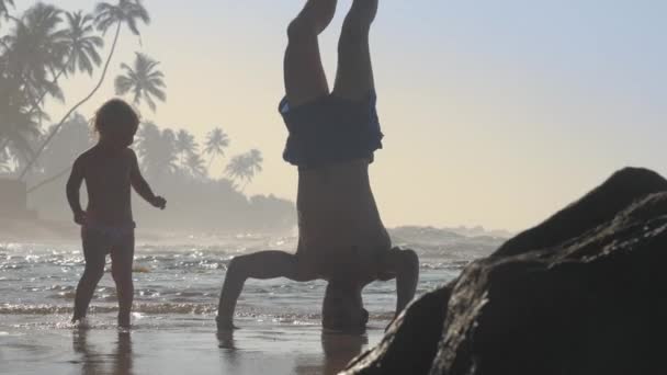 Ayah Berdiri Atas Kepala Dan Putri Bermain Pantai Laut — Stok Video