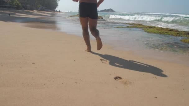 European Adult Man Jogging Sandy Beach Coast Ocean Waves Sunny — Stock Video