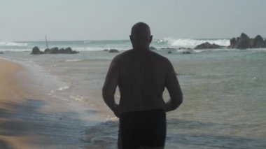 Adam formda. Long Beach boyunca koşuyor. Cennetin tadını çıkarıyor.