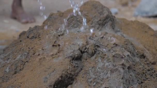Voda padá na betonovou hromadu se žlutým pískem před smícháním — Stock video