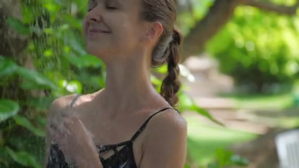 Жінка мандрівник приймає свіжий душ насолоджуючись розкішним відпочинком — стокове відео