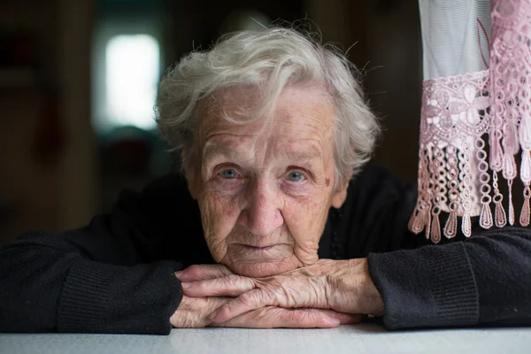 Elderly woman looking at camera — Stock Photo, Image