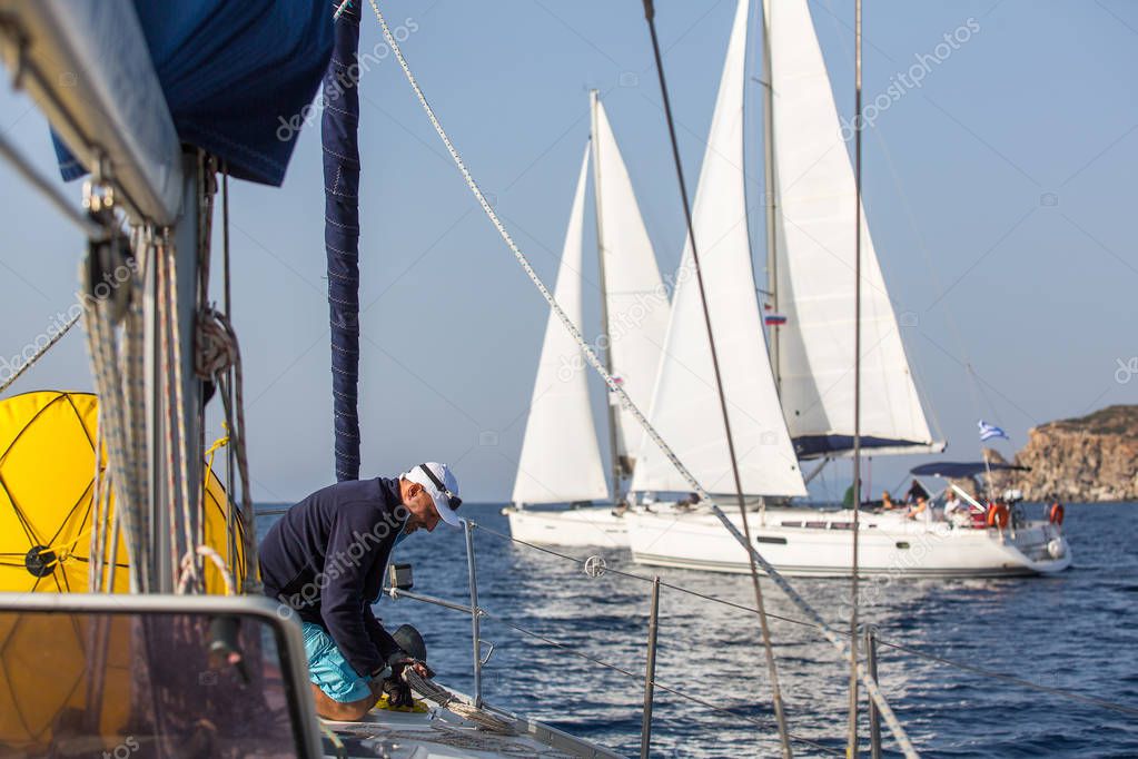 Man skipper on the sailing boat