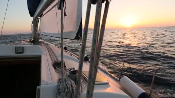 Zeilschip met witte zeilen tijdens zonsondergang. — Stockvideo