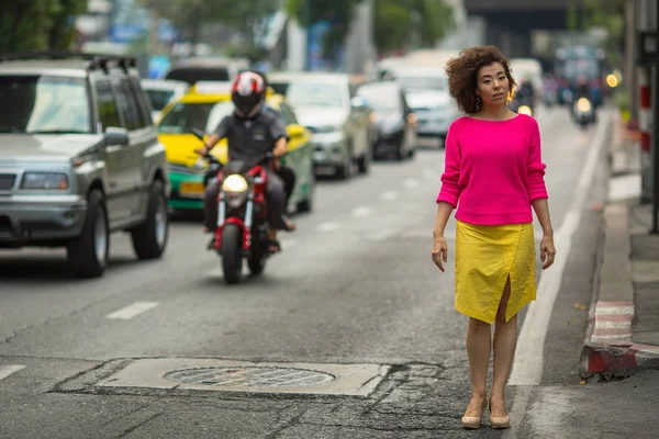 Asijské žena u rušné silnice — Stock fotografie