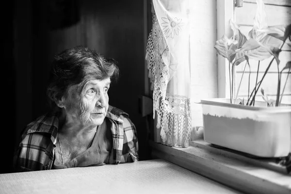 Woman sitting near window — Stock Photo, Image