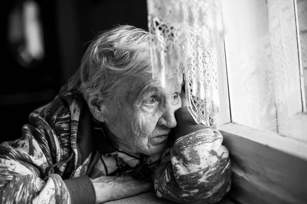 Woman sitting near window — Stock Photo, Image