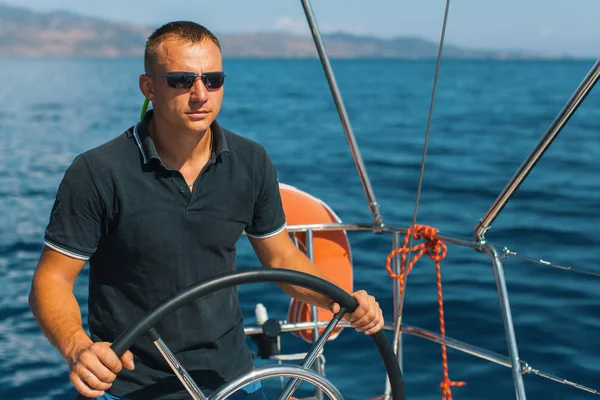 Handsome man on sailing boat. — Stock Photo, Image