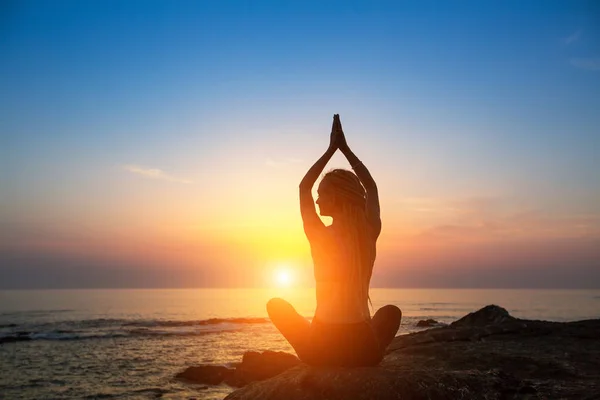 Meditation girl on ocean beach Stock Photo