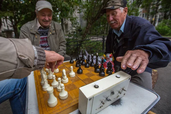Pensioners play chess in the courtyard — Stock Photo, Image