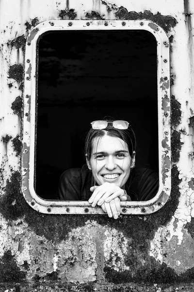 Girl in a rusty industrial car — Stock Photo, Image