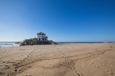 Miramar Beach and chapel Senhor da Pedra clipart