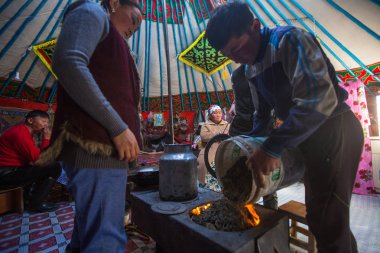 SAGSAI, BAYAN-OLGIY, MONGOLIA - SEP 28, 2017: Kazakh family of hunters with golden eagles inside the mongolian Yurt. In Bayan-Olgii Province is populated mainly by Kazakhs (88,7%)