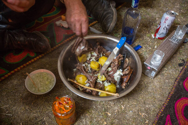 SAGSAI, BAYAN-OLGIY, MONGOLIA - SEP 28, 2017: Kazakh family of hunters with golden eagles inside the mongolian Yurt. In Bayan-Olgii Province is populated mainly by Kazakhs (88,7%)
