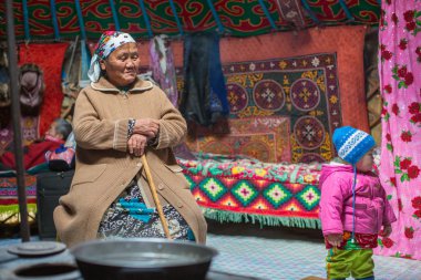 SAGSAI, BAYAN-OLGIY, MONGOLIA - SEP 28, 2017: Kazakh family of hunters with golden eagles inside the mongolian Yurt. In Bayan-Olgii Province is populated mainly by Kazakhs (88,7%)