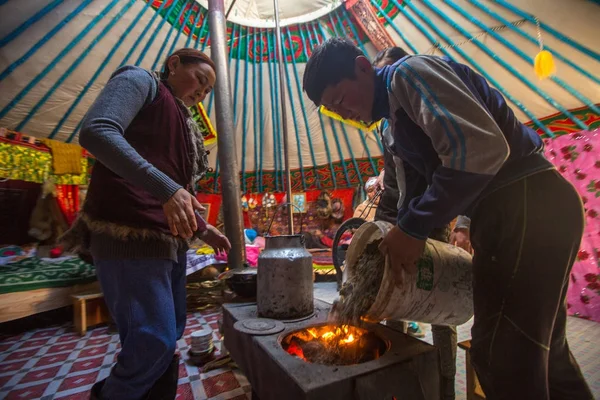 SAGSAI, BAYAN-OLGIY, MONGOLIA - SEP 28, 2017: Kazakh family of hunters with golden eagles inside the mongolian Yurt. In Bayan-Olgii Province is populated mainly by Kazakhs (88,7%)