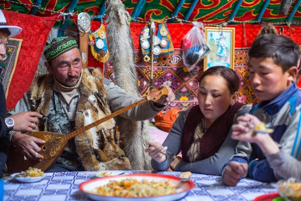 SAGSAI, BAYAN-OLGIY, MONGOLIA - SEP 28, 2017: Kazakh family of hunters with golden eagles inside the mongolian Yurt. In Bayan-Olgii Province is populated mainly by Kazakhs (88,7%)