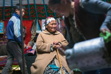 SAGSAI, BAYAN-OLGIY, MONGOLIA - SEP 28, 2017: Kazakh family of hunters with golden eagles inside the mongolian Yurt. In Bayan-Olgii Province is populated mainly by Kazakhs (88,7%)