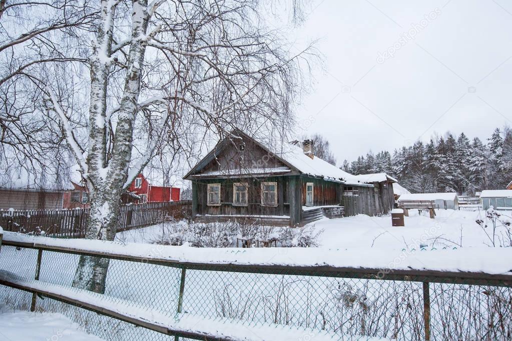 Village houses in winter in the Leningrad region of Russia.