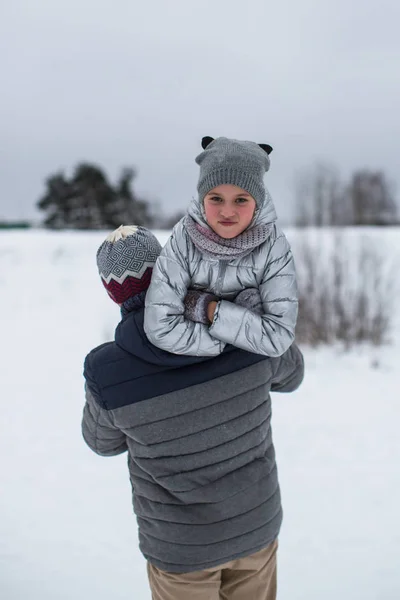 小さな女の子が雪の中公園でパパと一緒に遊んで — ストック写真