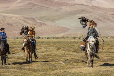 Sagsay, Moğolistan - 28 Eylül 2017: Kartal avcı kuşları ile tavşan içinde çöl Dağ Batı Moğolistan için avcılık genç kızı öğretir..
