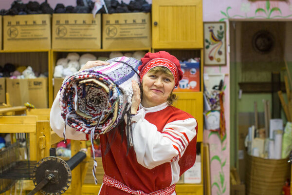 VAZHINY, RUSSIA - DEC 21, 2017: Weaver while working in the Textile Studio of decorative art (Tekstilnaya Plastika) at municipal budgetary institution of culture.