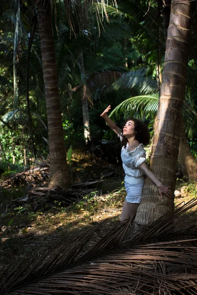Beautiful asian woman in the tropical jungle.