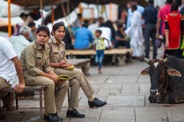 VARANASI, INDIA - MAR 29, 2018: Police patrol the streets of the city. According to legends, the city was founded by God Shiva about 5000 years ago. clipart