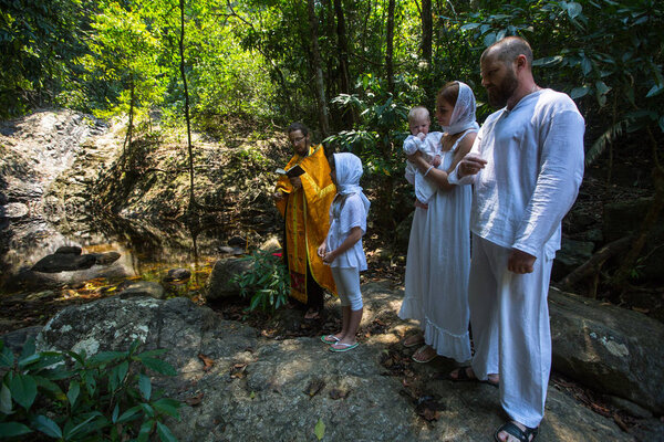 KOH CHANG, THAILAND - MAR 10, 2018: During Baptism - Christian sacrament of spiritual birth. There are currently 10 Orthodox parishes in Thailand, Orthodoxy is practiced by 0.002% of population.