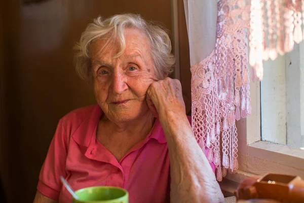 Elderly Woman Sits Kitchen Table — Stock Photo, Image